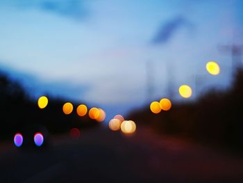 Defocused image of illuminated street lights at night