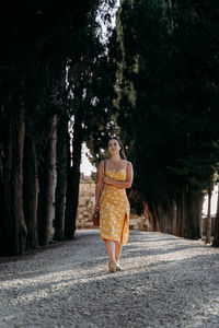 Rear view of woman standing in forest