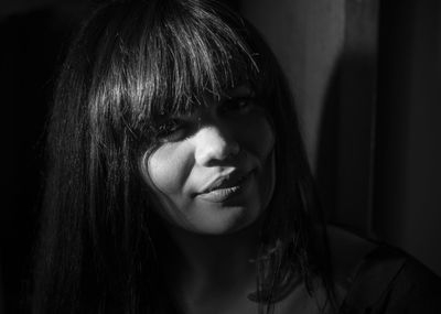 Close-up portrait of woman in darkroom