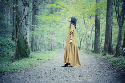 Man walking on footpath in forest