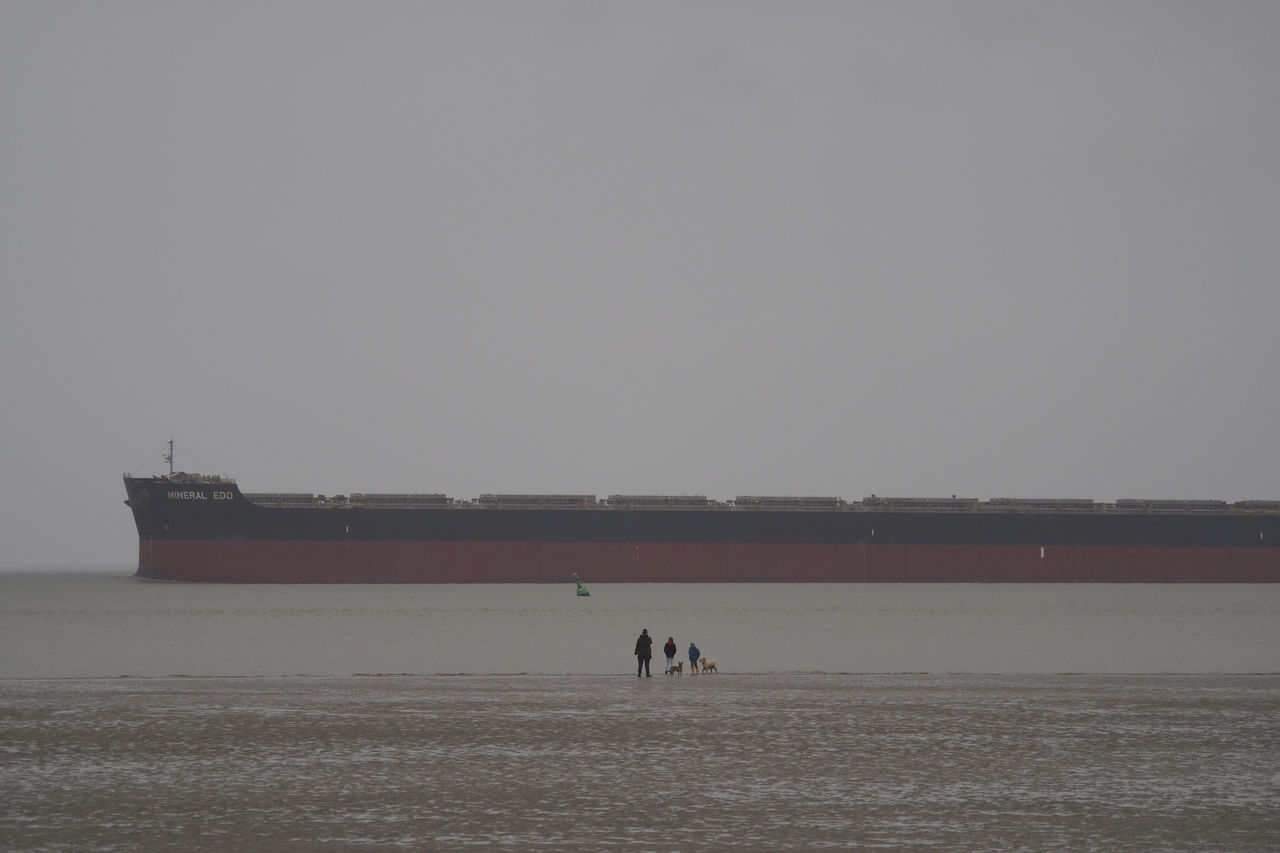 PEOPLE ON BOAT AGAINST CLEAR SKY