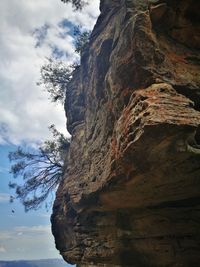 Low angle view of rock formation against sky