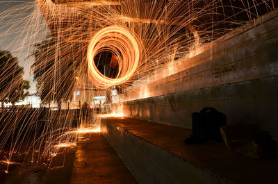 Blurred motion of man with fire crackers at night