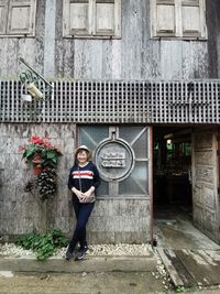 Portrait of smiling man standing against building