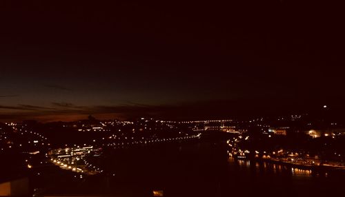 High angle view of illuminated buildings against sky at night