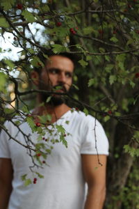 Midsection of man standing by tree