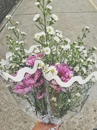 Midsection of person holding bouquet