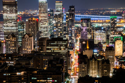 Aerial view of illuminated buildings in city at night