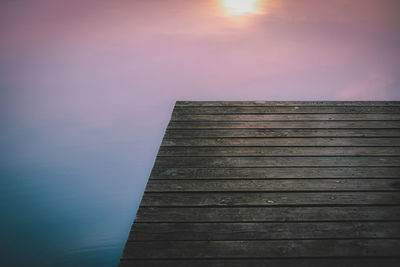 Low angle view of pier against sky during sunset