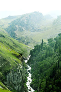 High angle view of green landscape against sky