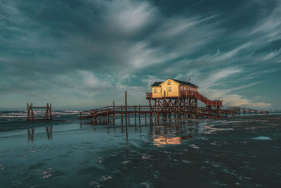 Pile dwelling on the beach of sankt peter-ording in germany.