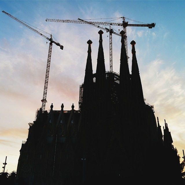 LOW ANGLE VIEW OF BUILT STRUCTURES AGAINST SUNSET