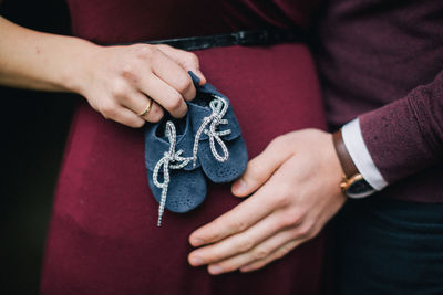 Midsection of couple holding hands