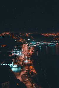 High angle view of illuminated buildings in city at night