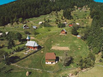 High angle view of trees and houses on field