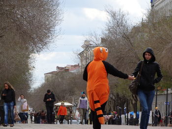 People standing in park against sky