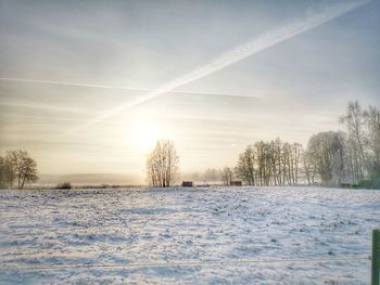 Snow covered field against sky