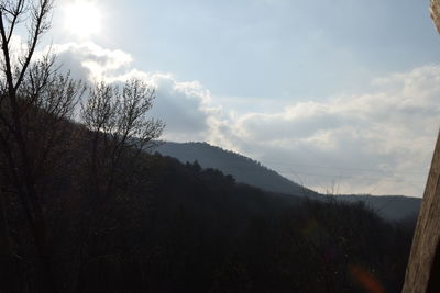 Scenic view of mountains against cloudy sky