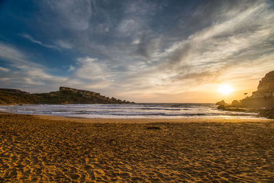 Scenic view of beach against sky during sunset