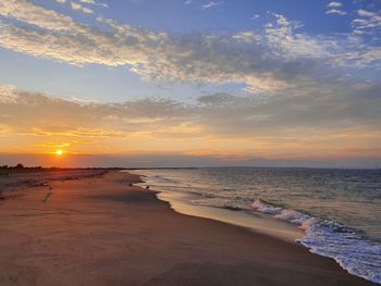 Scenic view of beach against sky during sunset