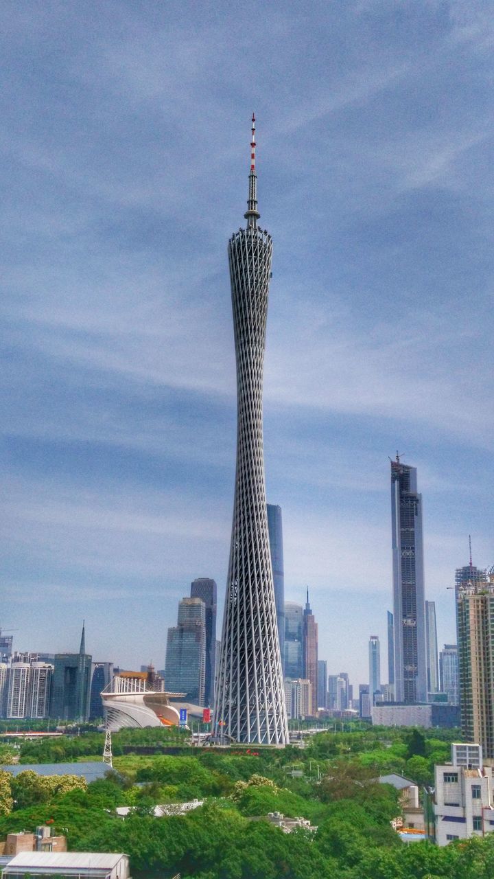 architecture, building exterior, built structure, city, tall - high, skyscraper, tower, modern, sky, capital cities, famous place, office building, travel destinations, cityscape, international landmark, tourism, cloud - sky, travel, urban skyline, financial district