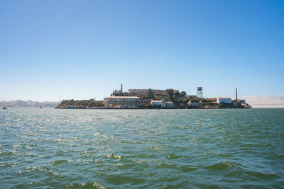 Scenic view of sea against clear blue sky