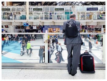 Rear view of people walking in airport