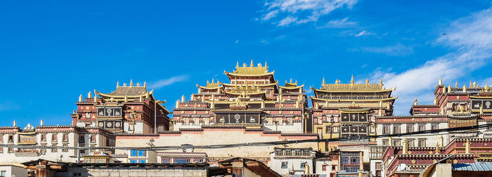 Low angle view of buildings in city against sky