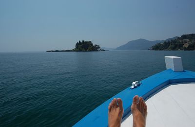 Low section of person in boat on sea