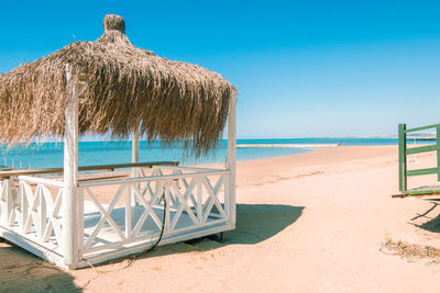 Massage huts with thatched roof on sand beach along seaside. luxury vacation resort spa