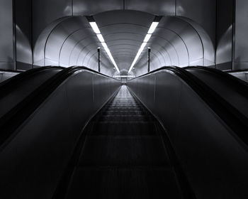 Empty illuminated walkway in modern building