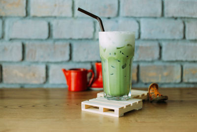 Close-up of drink on table against wall