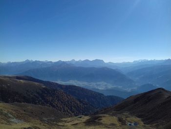 Scenic view of mountains against clear blue sky