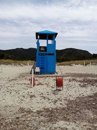 Lifeguard hut on beach against sky