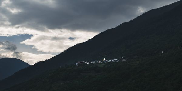 Scenic view of mountains against sky at dusk