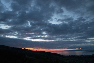 Scenic view of dramatic sky over silhouette landscape