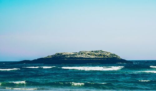 Scenic view of sea against clear blue sky