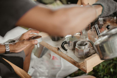 Midsection of woman working on wood