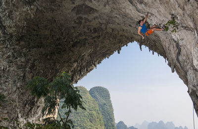 Man climbing on moon hill in yangshuo, a climbing mekka in china