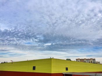 Low angle view of house against cloudy sky