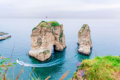 Panoramic view of rock formation in sea against sky