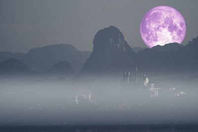 Scenic view of silhouette mountains against sky at night