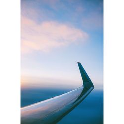 Airplane on landscape against blue sky