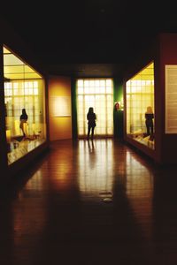 People walking in corridor of building