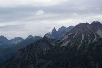 Scenic view of mountains against cloudy sky