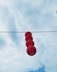 Low angle view of lanterns hanging against sky