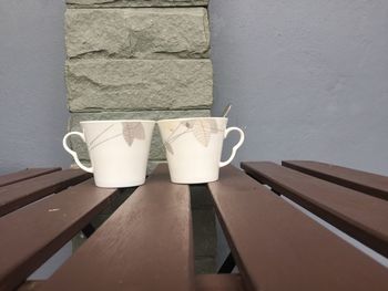 Close-up of white wine on table against wall