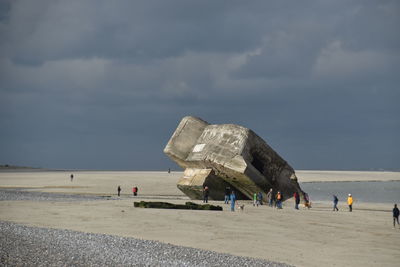 People on beach against sky