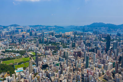 Aerial view of buildings in city against sky