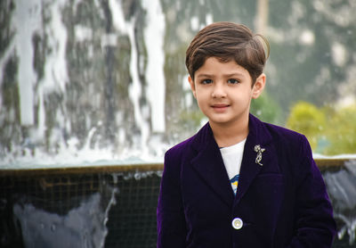 Portrait of boy standing outdoors